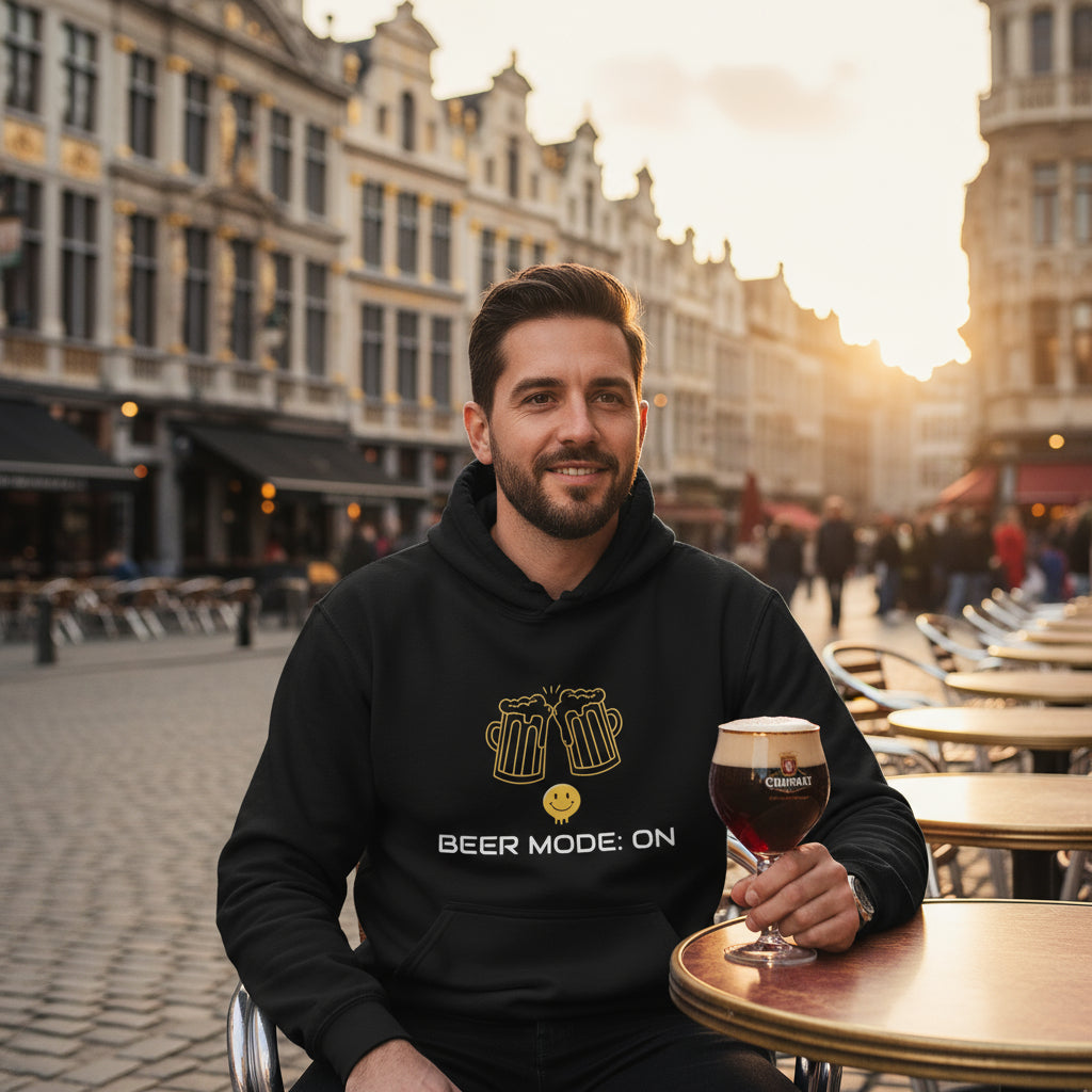 Beer Mode On premium black hoodie lifestyle photo Brussels beer café Belgium Grand Place - man mid-30s dark hair beard cobblestone street Trappist beer glass Belgian ale traditional architecture - bold white text graphic craft beer aficionado European beer culture Belgian beer heritage pub clothing unisex hoodie Guapo Originals Premium Designer Collection €39.99 Spain