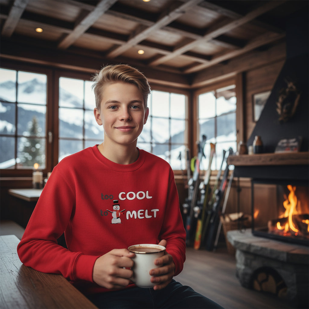 Youth Snowman Sweatshirt red Too Cool to Melt design front lifestyle photo Swiss Alps ski resort tavern après-ski - snowman design chest blonde boy age 14 hot chocolate alpine chalet interior fireplace - youth ski vacation Swiss Alps mountain tavern winter comfort ages 8-16 Guapo Originals Youth €34.99 Spain

