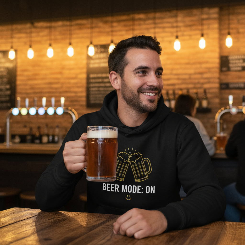 Beer Mode On premium black hoodie lifestyle photo Munich beer hall Germany - handsome man early 30s brown hair authentic Hofbräuhaus traditional Bavarian pub communal table large stein golden lager - bold white text graphic craft beer enthusiast unisex hoodie beer culture fashion Oktoberfest style pub clothing Guapo Originals Premium Designer Collection €39.99 Spain
